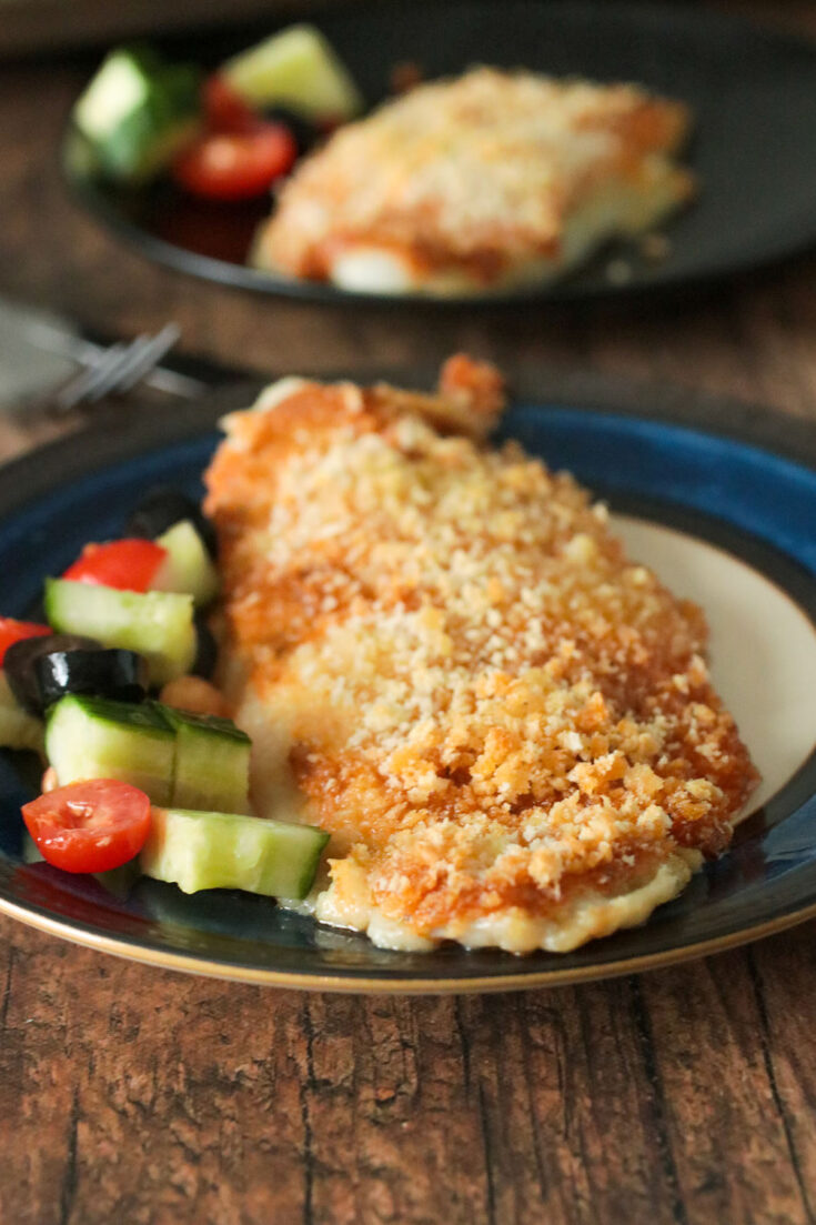 Baked fish fillet served on a plate.